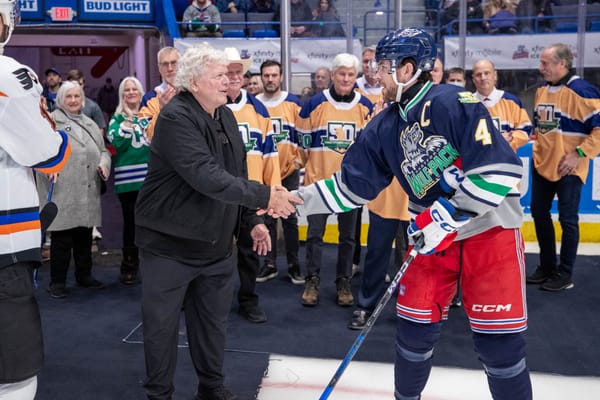 Hartford Wolf Pack captain Casey Fitzgerald shakes hands with former Hartford Whalers owner Howard Baldwin, 1/11/25.